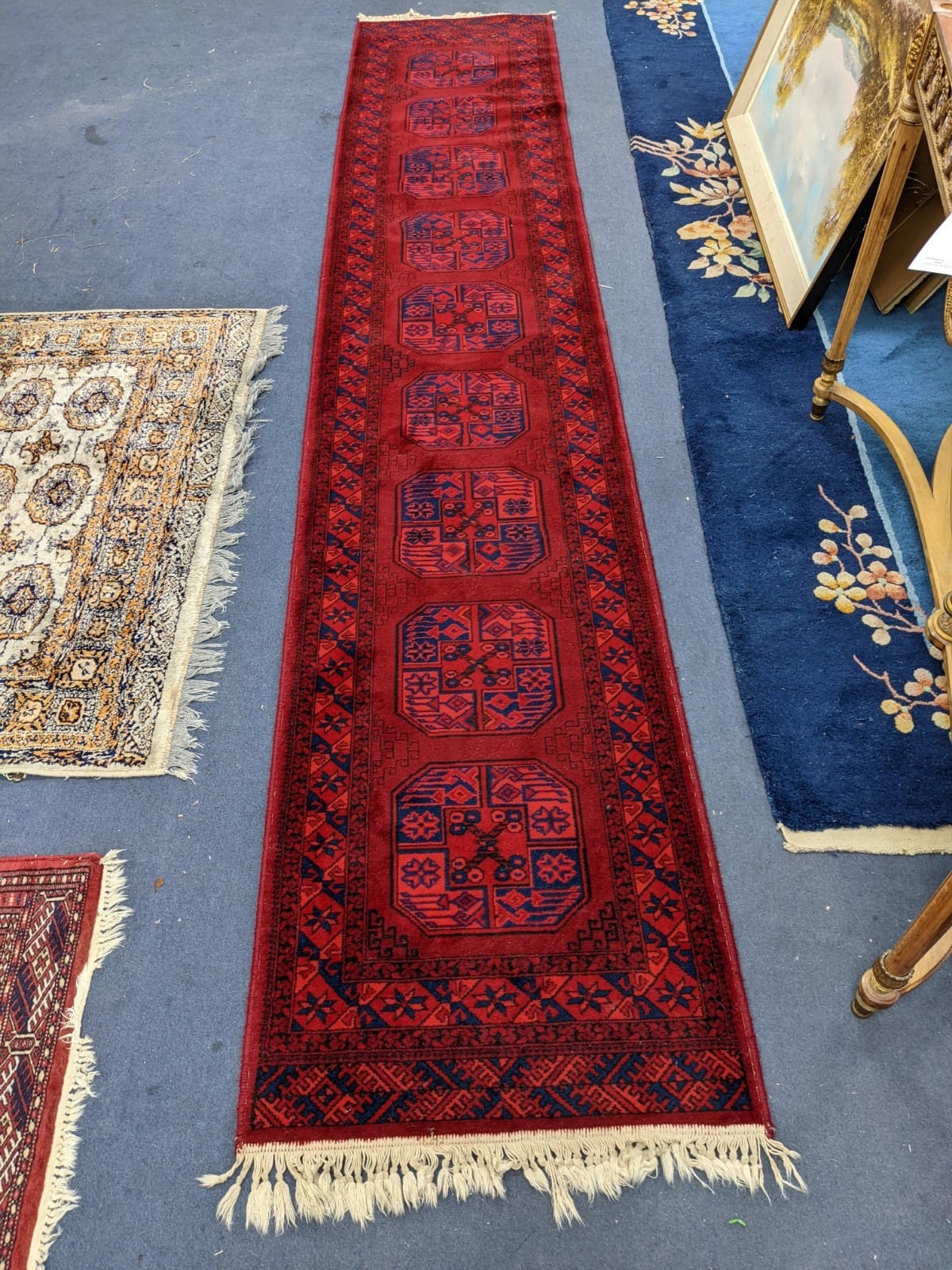 An Afghan red ground runner, 360 x 68cm and a Bokhara rug